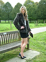 Sexy Kim posing outdoors in a fur coat and some sexy high heels